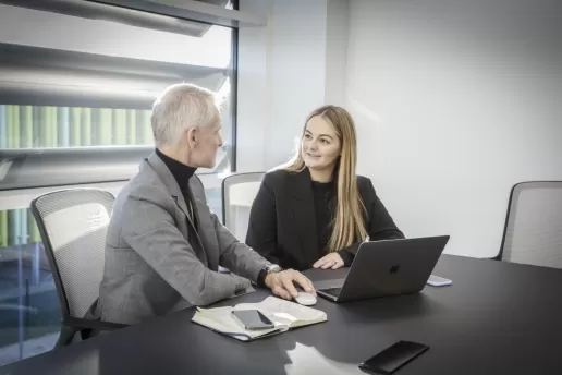 A businessman and businesswoman meeting in a data centre office